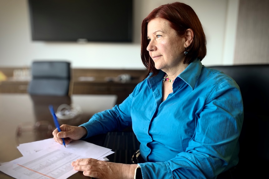 Woman reads at desk