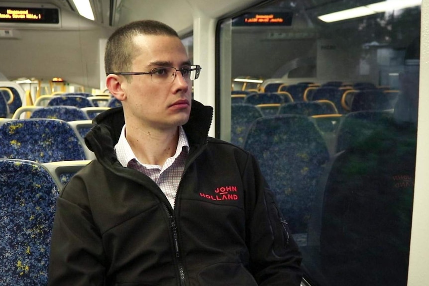 A man sits on a train