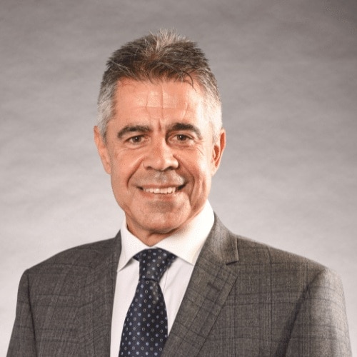 A head shot of a man wearing a suit and tie.