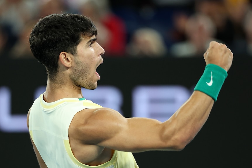 Carlos Alcaraz pumps his fist and shouts at the Australian Open.