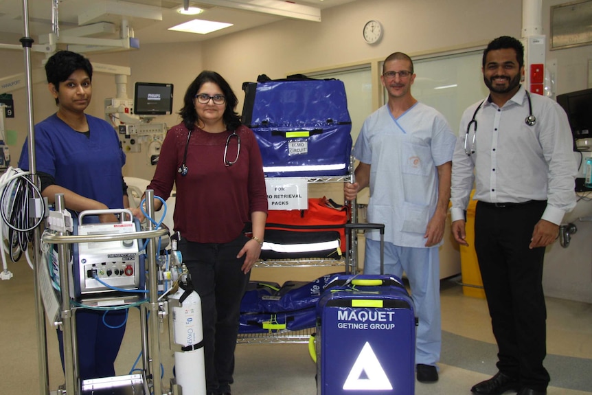 Staff from the Prince Charles Hospital and the ECMO machine.