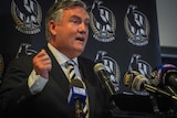 A tearful Eddie McGuire gestures while speaking