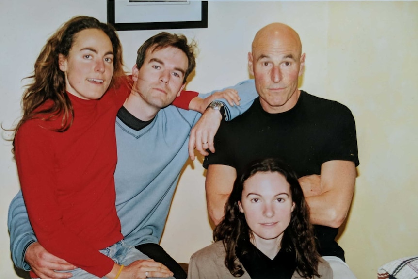 Rory O'Donoghue sits with arms crossed next to his three adult children