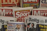 British newspapers are displayed at a newsagent's stand