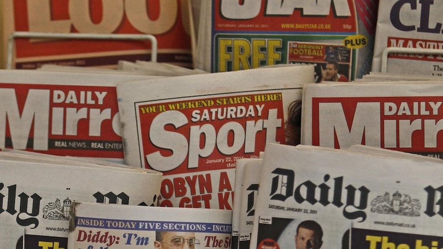 British newspapers are displayed at a newsagent's stand