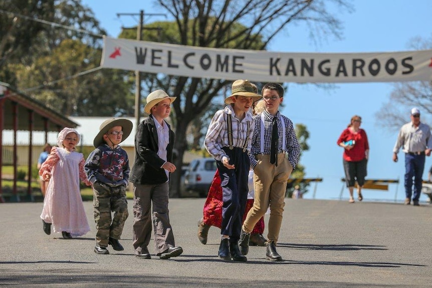 Schoolchildren dressed up in World War I era attire to welcome a re-enactment of the 1915 Kangaroo March