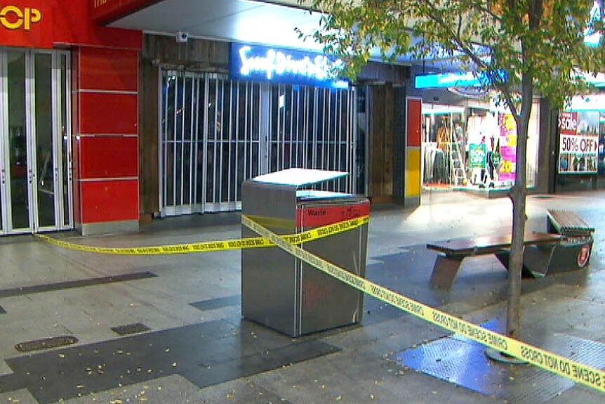 Crime scene table wrapped around a bin blocking off parts of Rundle Mall