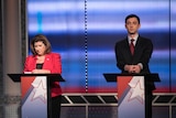 Republican Karen Handel and Democrat Jon Ossoff stand side by side at two podiums for a debate