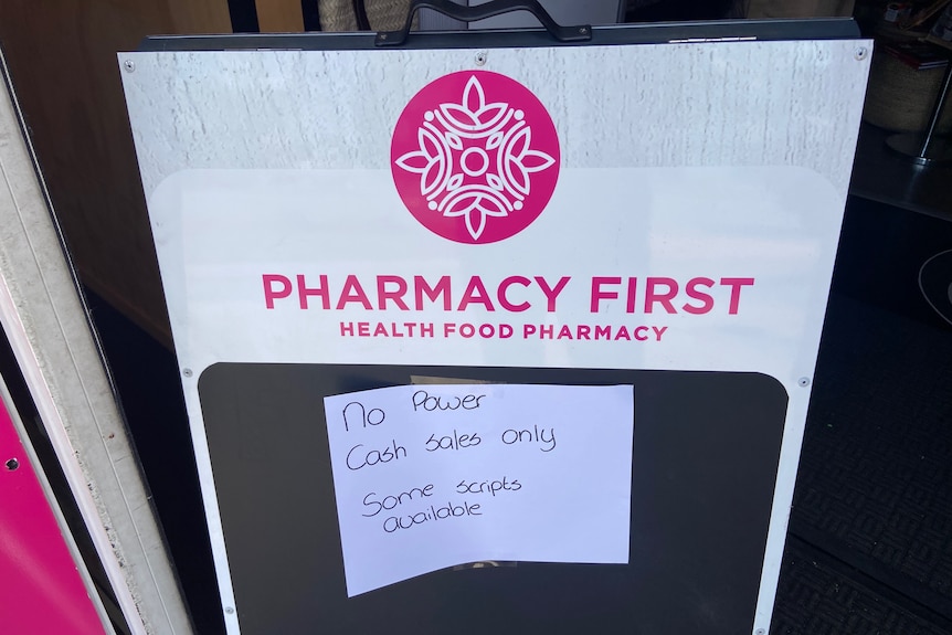A sign on a pharmacy window that says "no power, cash sales only".