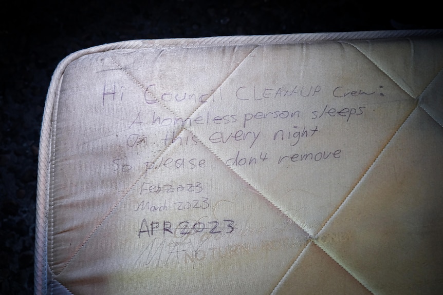 A mattress with writing telling council rubbish collectors that a homeless man is using it, and not to remove the mattress