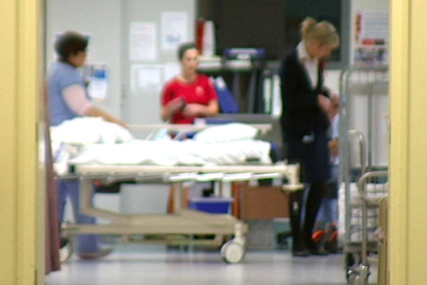 Nurses standing in hospital room, blurred out