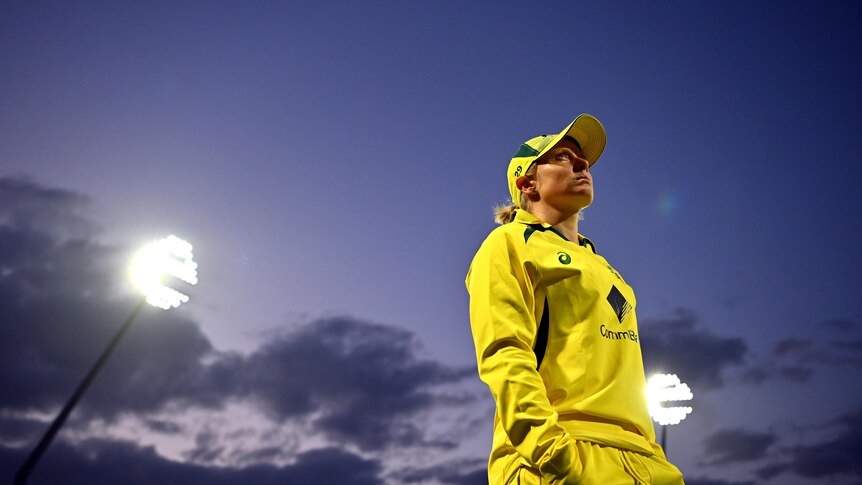 Australia captain Alyssa Healy stands under lights after a cricket game at Edgbaston.