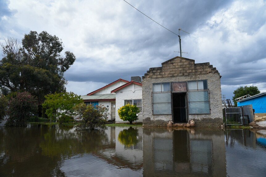 A house with floodwater in the foreground