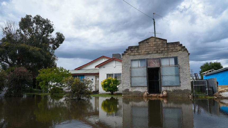 A house with floodwater in the foreground