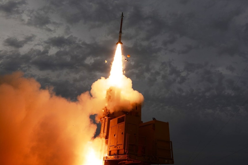 An air defence system firing a missile. 