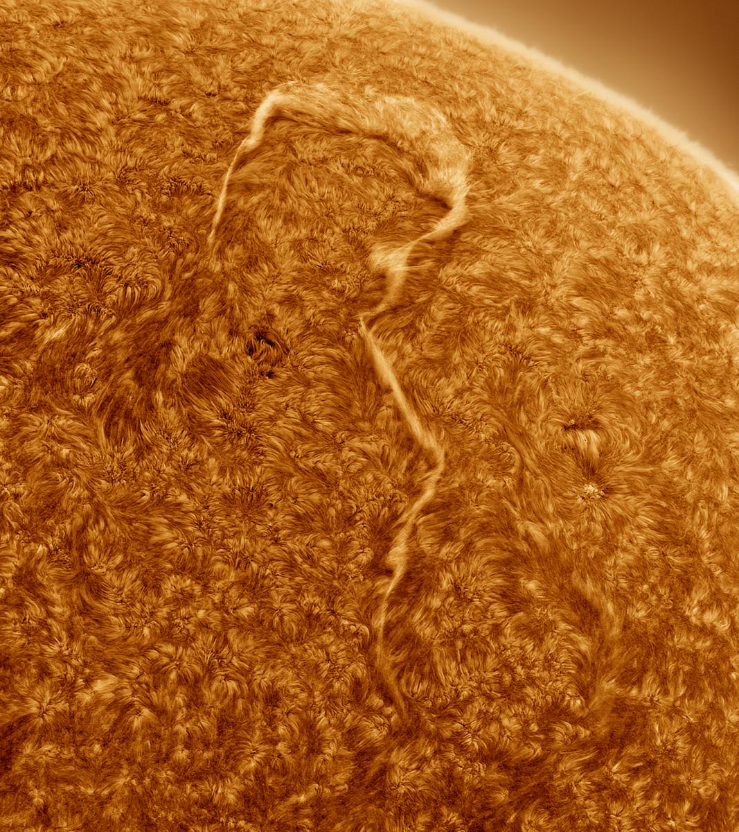 An up close image of the sun with a question mark.