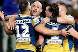 Four Parramatta Eels congregate for a group hug in celebration