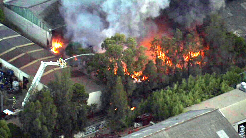 Revesby fire: 100 firefighters battle blaze, two men injured - ABC News