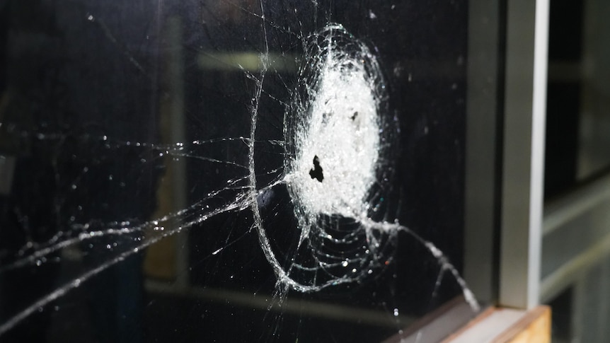a smashed window at night