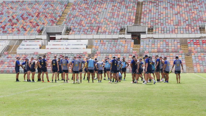 Large group of young men in the middle of football field in Townsville old stadium