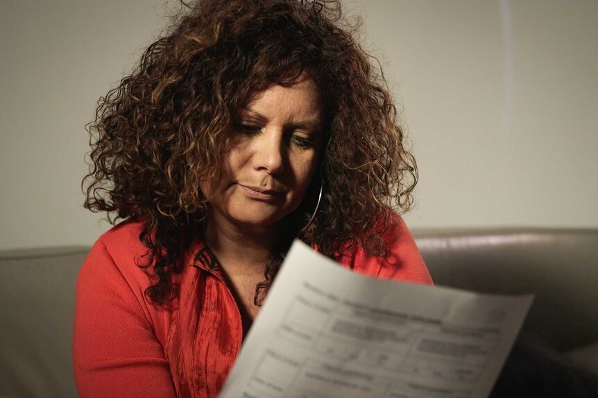 Malarndirri McCarthy purses her lips while looking at a piece of paper.