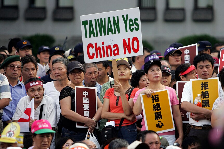 A group of Taiwanese protesters holding up signs, with one reading 'Taiwan yes, China no'