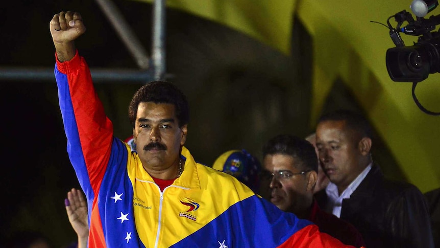 Venezuela's newly-elected president, Nicolas Maduro, gestures following the release of election results.