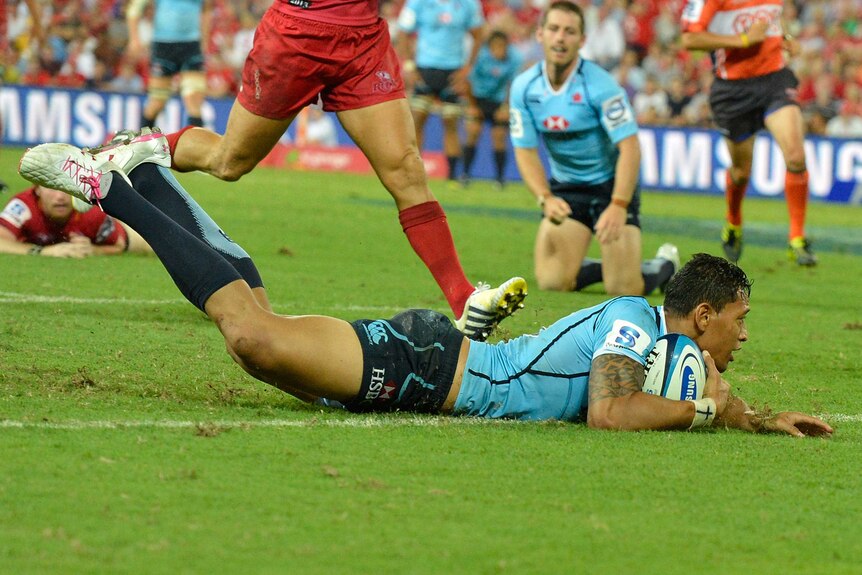 Try time ... Israel Folau's first try in Super Rugby on debut was not enough to contain the Reds at Lang Park.