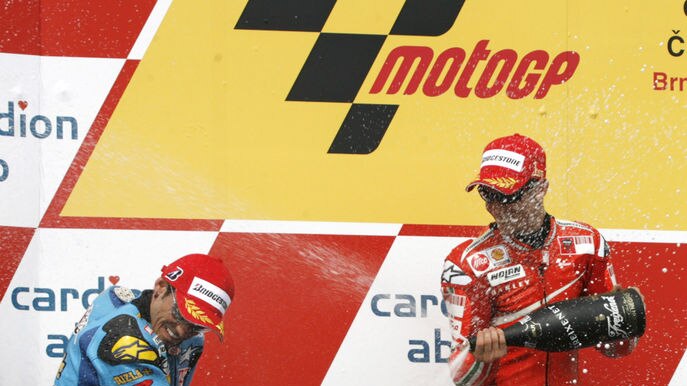 Another victory ... Casey Stoner (r) sprays champagne at John Hopkins