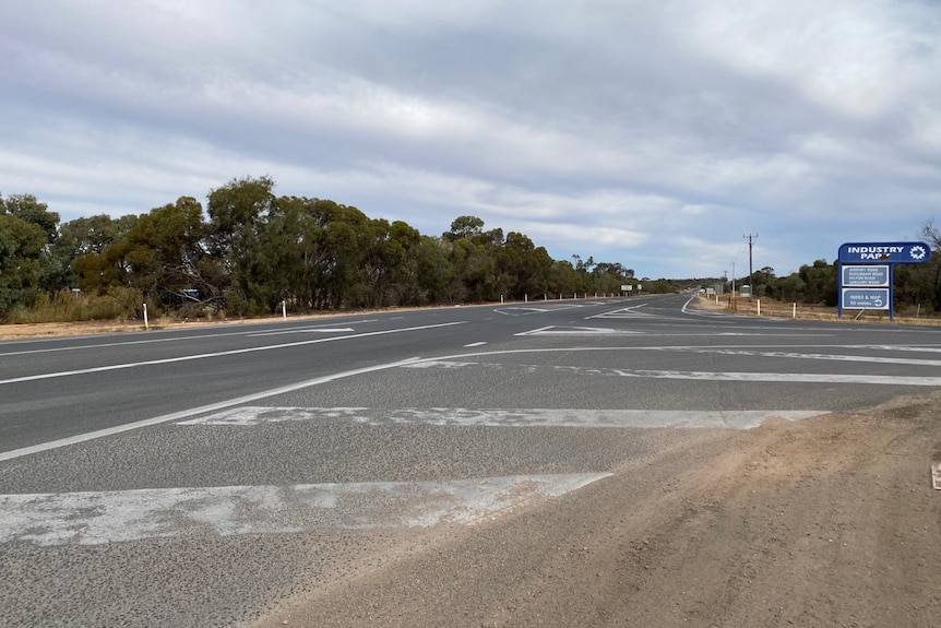 A deserted country intersection that has to accommodate turning trucks