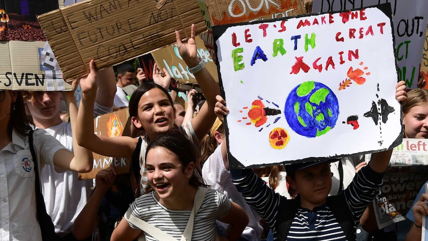 Young people demonstrate against climate change and signs to show their fears and frustrations about perceived inaction