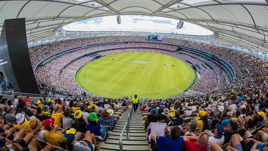 A wide shot from the top of the Perth Stadium stands showing a near-capacity crowd watching a cricket match.
