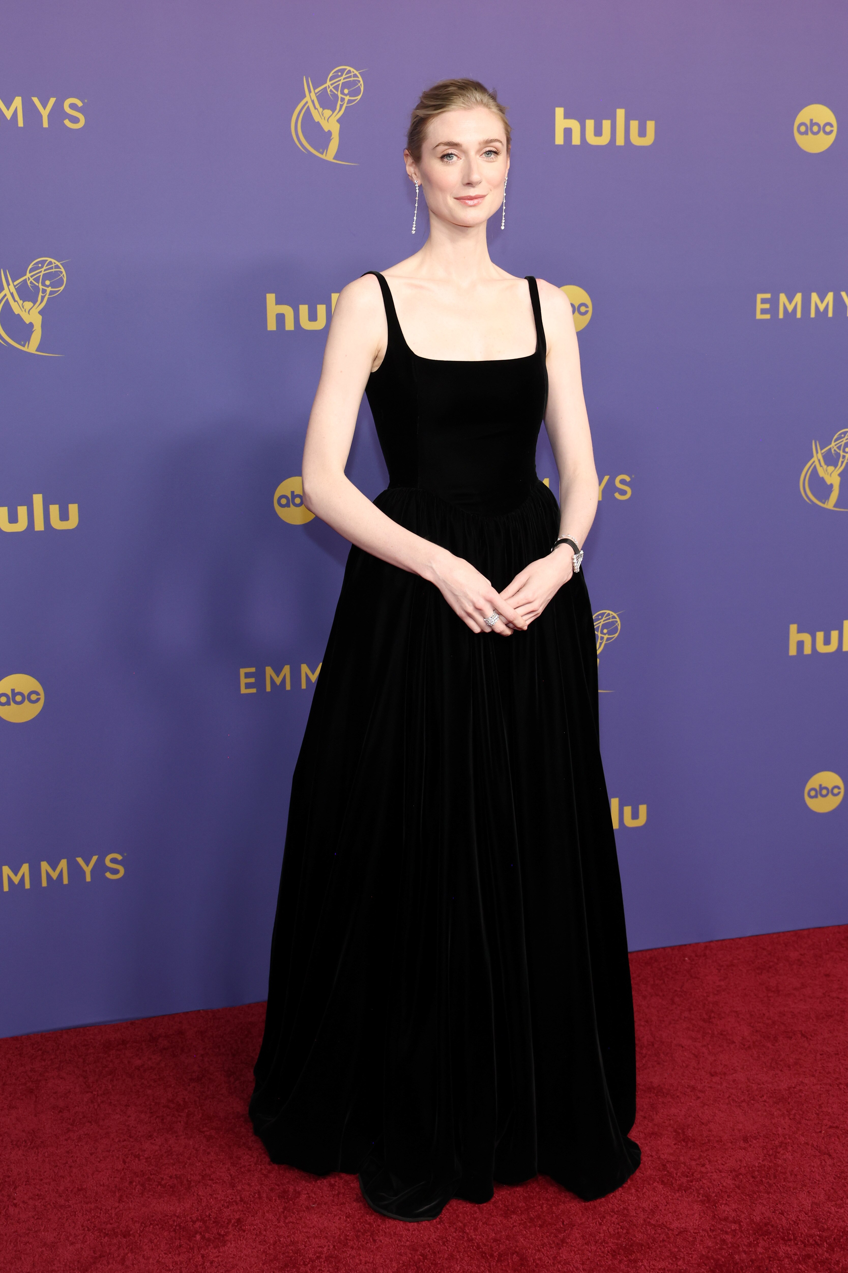  Elizabeth Debicki wearing a long black gown with thin traps