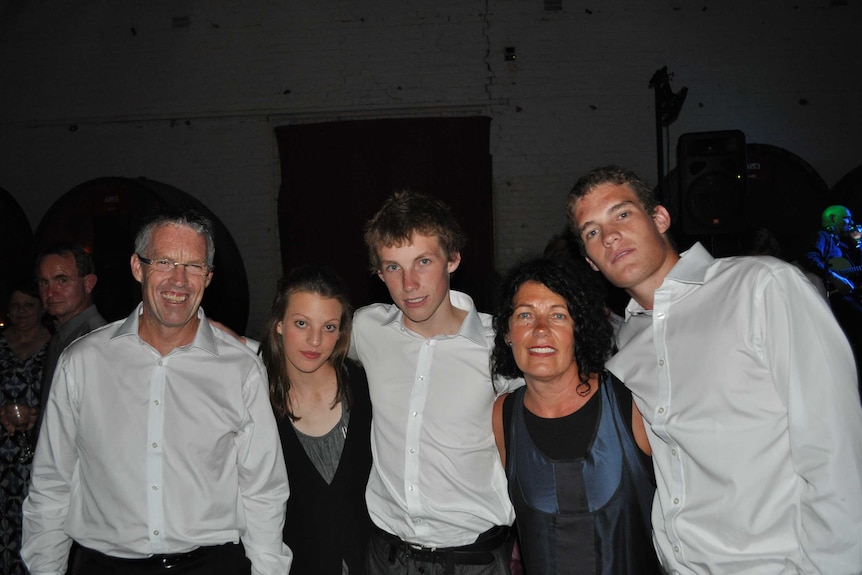 The Baker family poses for a photograph at a wedding