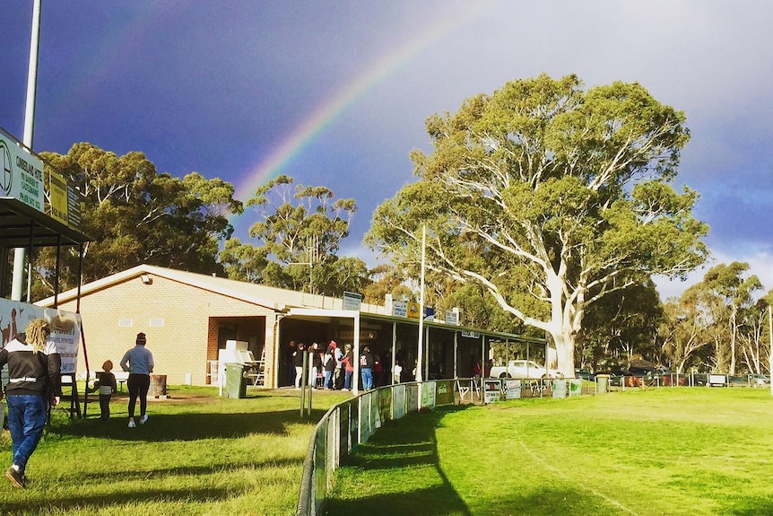 football club with a rainbow over it