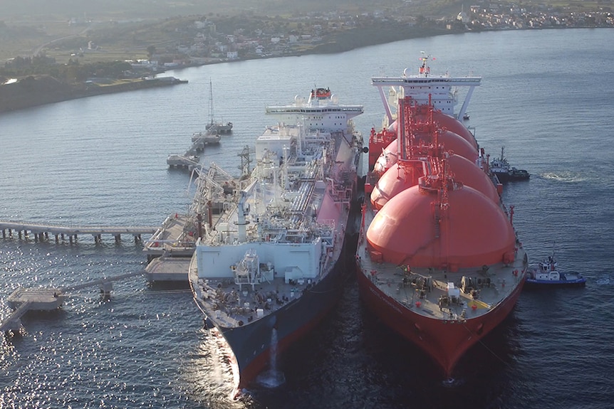 An LNG ship docking beside a floating gas import terminal.