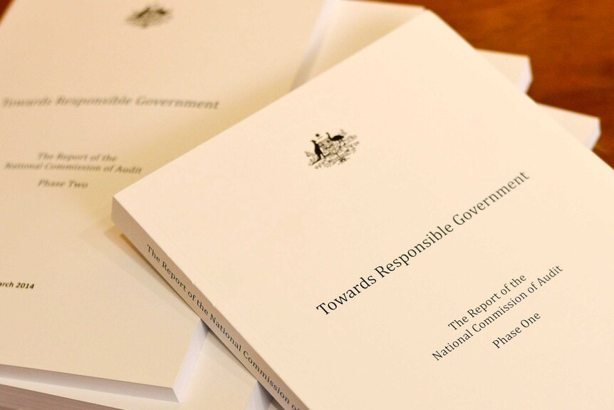 Copies of the Commission of Audit report sit on a desk during the lockup at Parliament House.