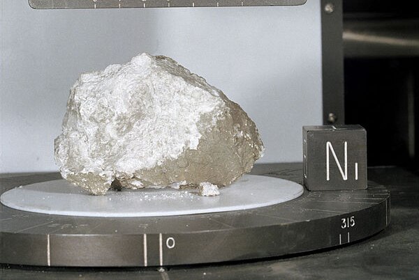 A rock sample collected from the Moons surface sits on a scientific device at NASA.