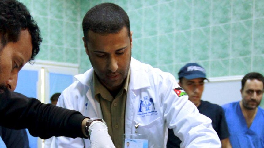 Medics treat an injured rebel fighter at the hospital in Ajdabiyah