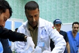 Medics treat an injured rebel fighter at the hospital in Ajdabiyah