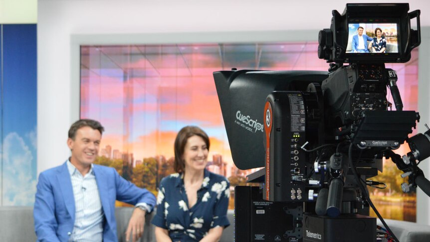 Studio camera filming Michael Rowland and Virginia Trioli sitting on News Breakfast couch while on air.