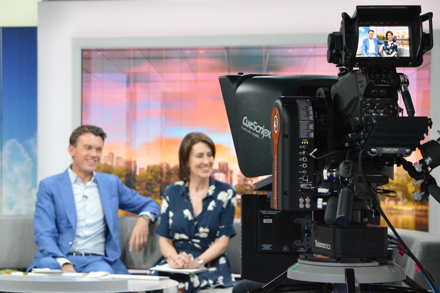 Studio camera filming Michael Rowland and Virginia Trioli sitting on News Breakfast couch while on air.