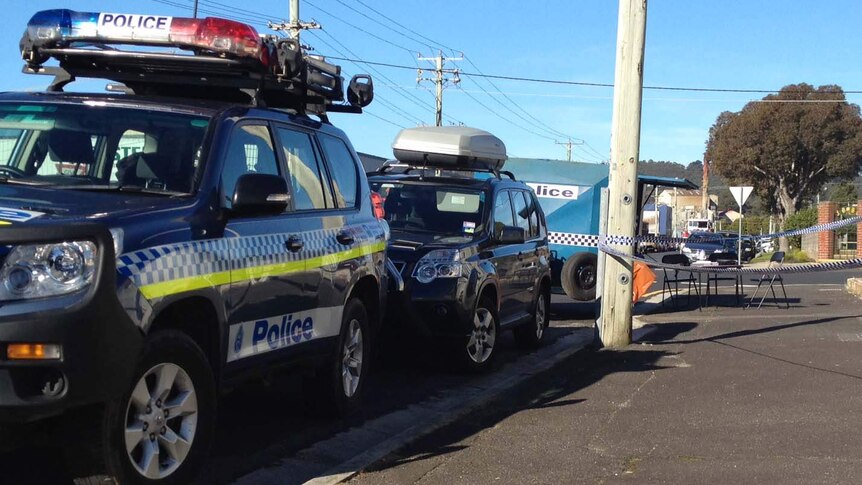Police cars in a South Burnie street where they are investigating the rape of an elderly woman.