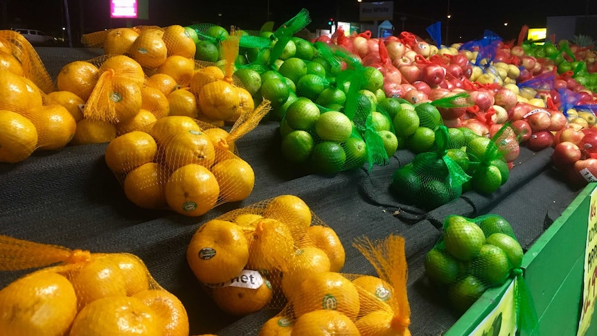 Selection of fruit in bags on a stand.