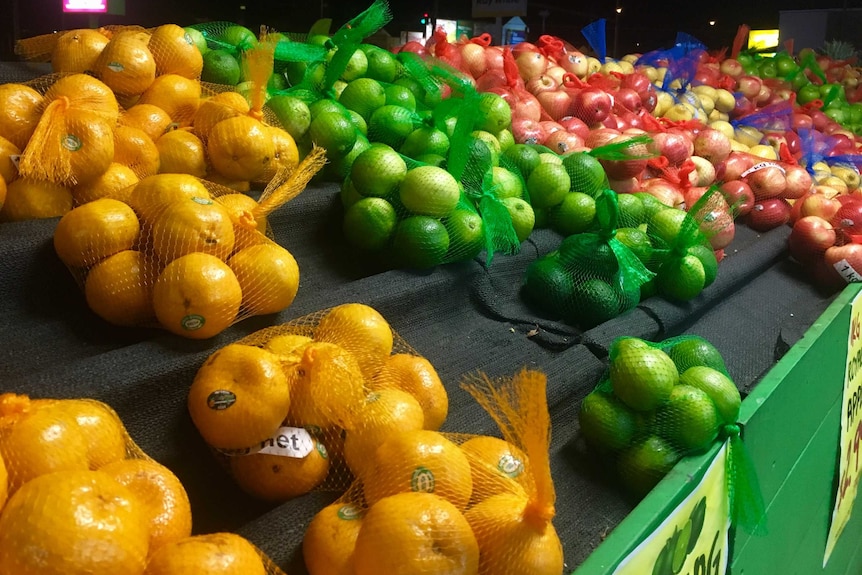 Selection of fruit in bags on a stand.
