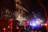 Firefighters respond to a blaze in a brown brick apartment building in New York.