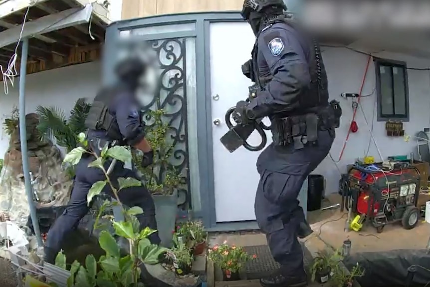Queensland police hold large black pole in raid on home in south-east Queensland centre of drug investigation