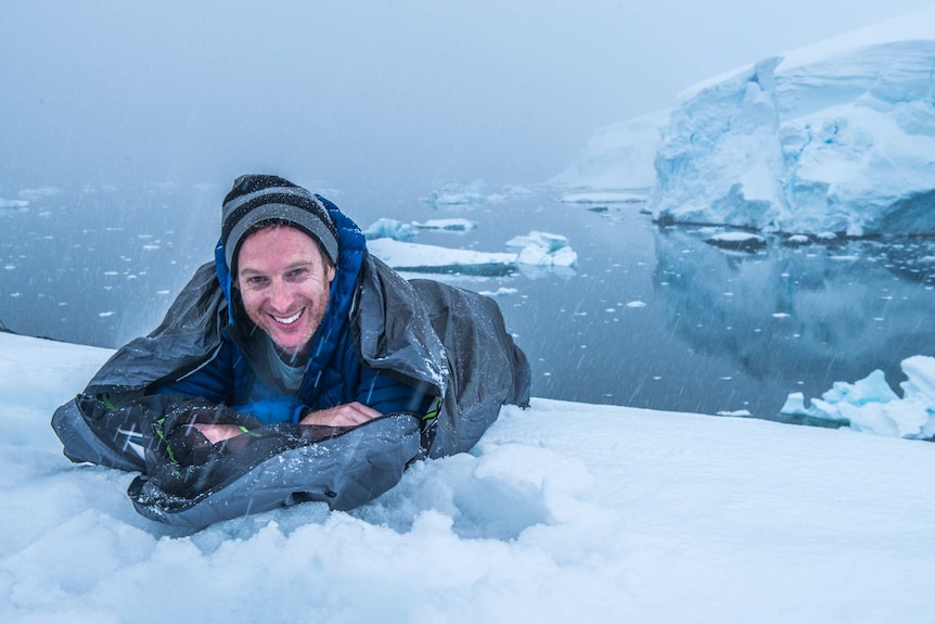 Robin Esrock snuggles into his sleeping bag in Antarctica.