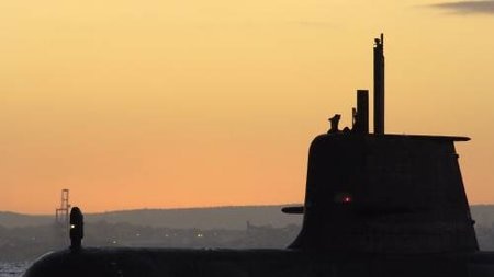 HMAS Collins transits through Cockburn Sound at sunrise.