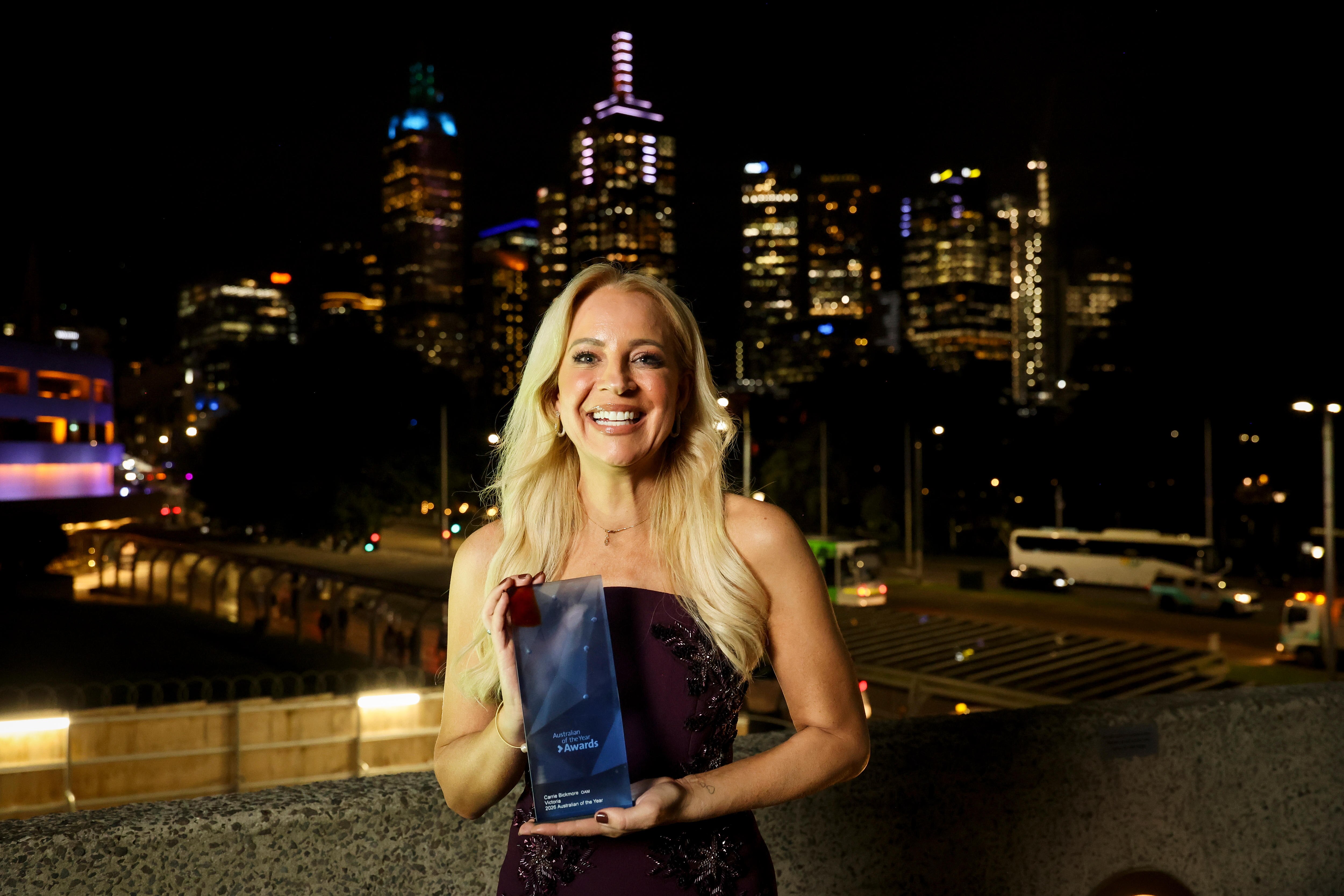 Carrie Bickmore holding an award.